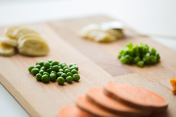 Image showing peas and other vegetables on wooden board