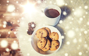 Image showing cups of hot chocolate with cookies on fur rug