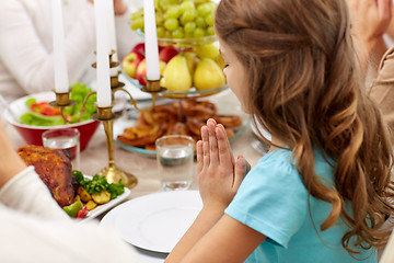 Image showing girl with family having dinner and praying at home