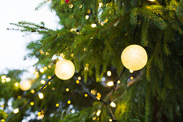 Image showing close up of christmas tree garland bulbs outdoors