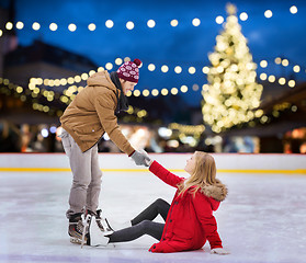 Image showing man helping woman on christmas skating rink