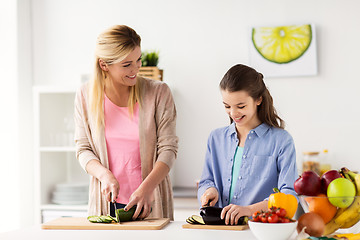 Image showing happy family cooking dinner at home kitchen