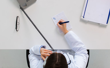 Image showing doctor with prescription calling on phone