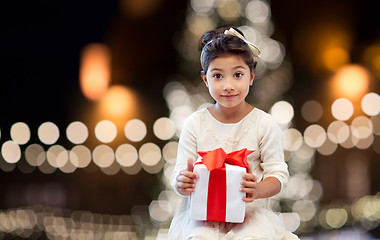 Image showing happy girl with gift box over christmas lights