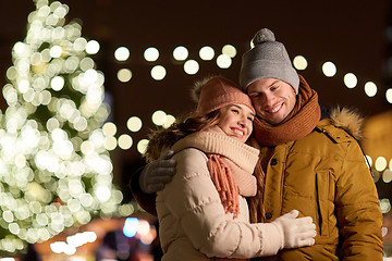 Image showing happy couple hugging at christmas tree