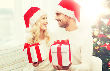 Image showing happy couple at home exchanging christmas gifts