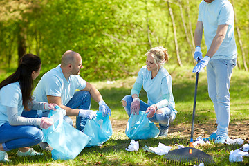 Image showing volunteers with garbage bags cleaning park area