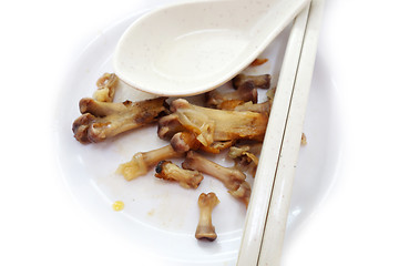 Image showing Chicken bones on a white plate