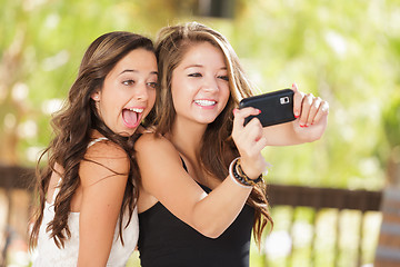 Image showing Two Attractive Mixed Race Girlfriends Using Their Smart Cell Pho