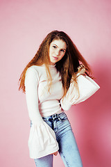 Image showing cute pretty redhair teenage girl smiling cheerful on pink background, lifestyle modern people concept