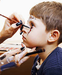 Image showing little cute child making facepaint on birthday party, zombie Apo