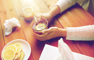 Image showing ill woman drinking tea with lemon and ginger