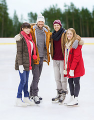 Image showing friends holding hands on outdoor skating rink