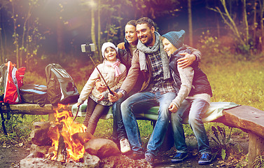 Image showing family with smartphone taking selfie near campfire