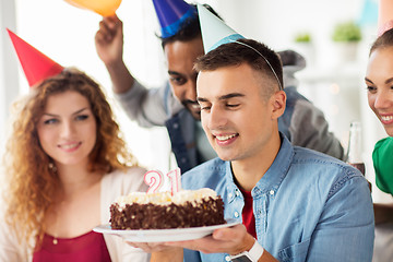 Image showing man with birthday cake and team at office party