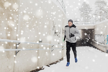 Image showing man running out of subway tunnel in winter