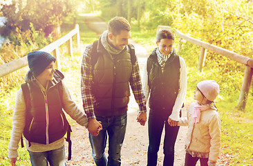 Image showing happy family with backpacks hiking