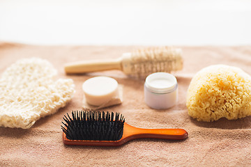 Image showing hair brush, cream, sponge, soap bar and bath towel