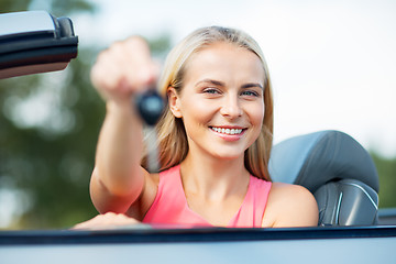 Image showing happy young woman with convertible car key