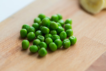 Image showing close up of green pea on wooden cutting board
