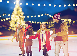 Image showing happy friends at christmas skating rink