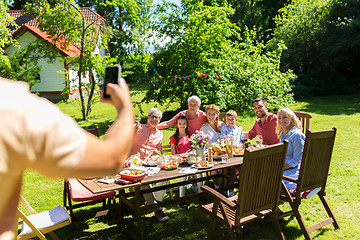 Image showing happy family photographing by smartphone in summer