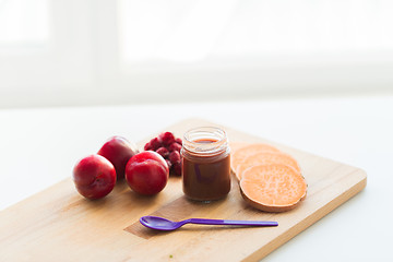 Image showing fruit puree or baby food in jar and feeding spoon