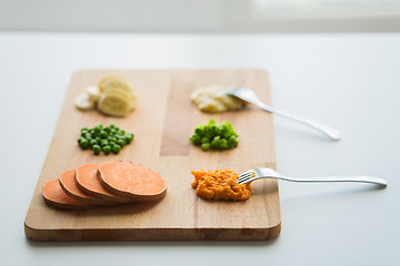 Image showing mashed fruits and vegetables with forks on board