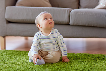 Image showing baby boy sitting on floor at home