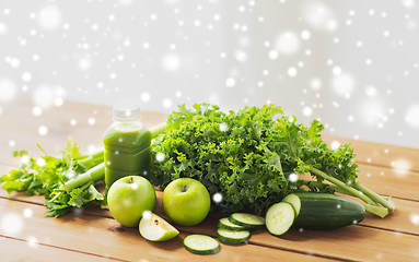 Image showing close up of bottle with green juice and vegetables