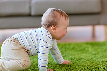 Image showing baby boy crawling on floor at home