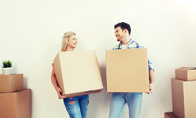 Image showing smiling couple with big boxes moving to new home