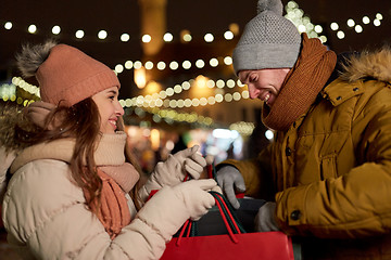 Image showing happy couple at with shopping bags in winter