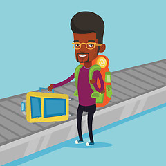 Image showing Man picking up suitcase on luggage conveyor belt
