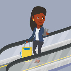 Image showing Woman using smartphone on escalator in airport.