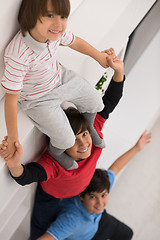 Image showing young boys posing line up piggyback top view