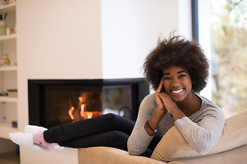 Image showing black woman in front of fireplace