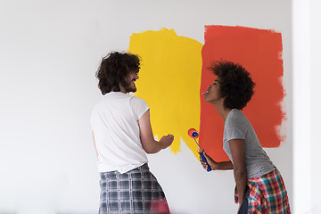 Image showing multiethnic couple painting interior wall