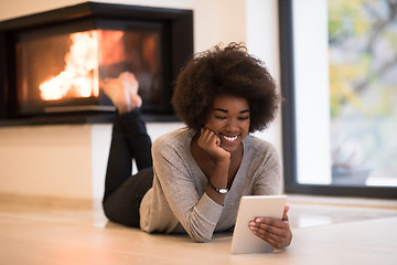 Image showing black women using tablet computer on the floor