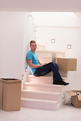 Image showing young man sitting in stairway at home