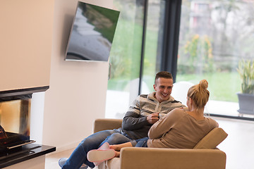 Image showing Young couple  in front of fireplace