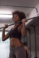 Image showing black woman lifting empty bar