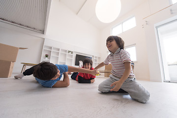 Image showing boys having fun with an apple on the floor