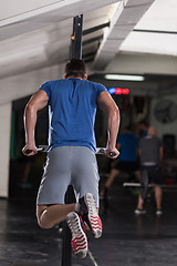 Image showing man doing exercises parallel bars