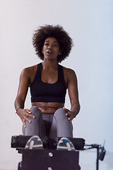 Image showing black woman doing sit ups at the gym