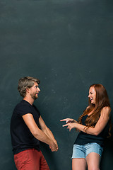 Image showing Beautiful woman impressed by the muscles of a bodybuilder, strong man showing off his muscles