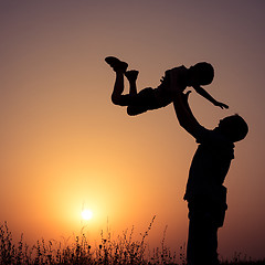 Image showing Father and son playing in the park at the sunset time.