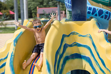 Image showing happy child playing on the swimming pool at the day time.