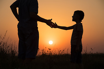 Image showing Father and son playing in the park at the sunset time.