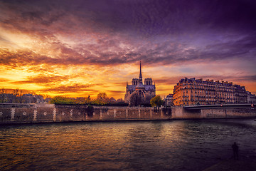 Image showing Notre Dame Cathedral with Paris cityscape at dusk